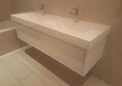 suspended vanity with 2 gloss white doors and two sinks and no handles