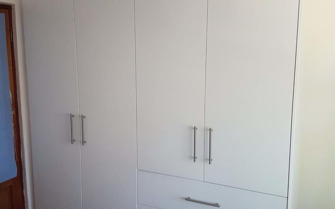 White bedroom built in cupboards with hanging space and draws on the side 2