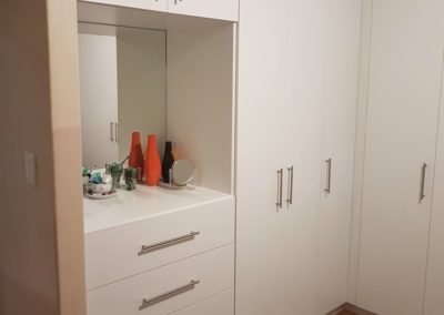 white built in cupboards with makeup counter 3