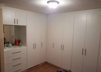 white built in cupboards with makeup counter