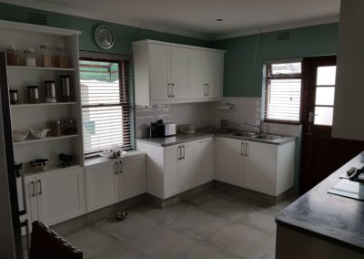 custom kitchen built out with white doors and light grey countertops 2