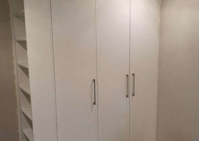 custom built in cupboards in white with shelving on the side in cape town 2
