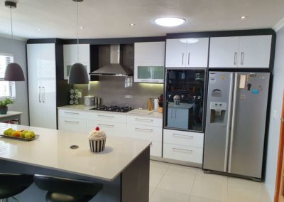 custom kitchen installation in cape town featuring light countertops and gloss white doors