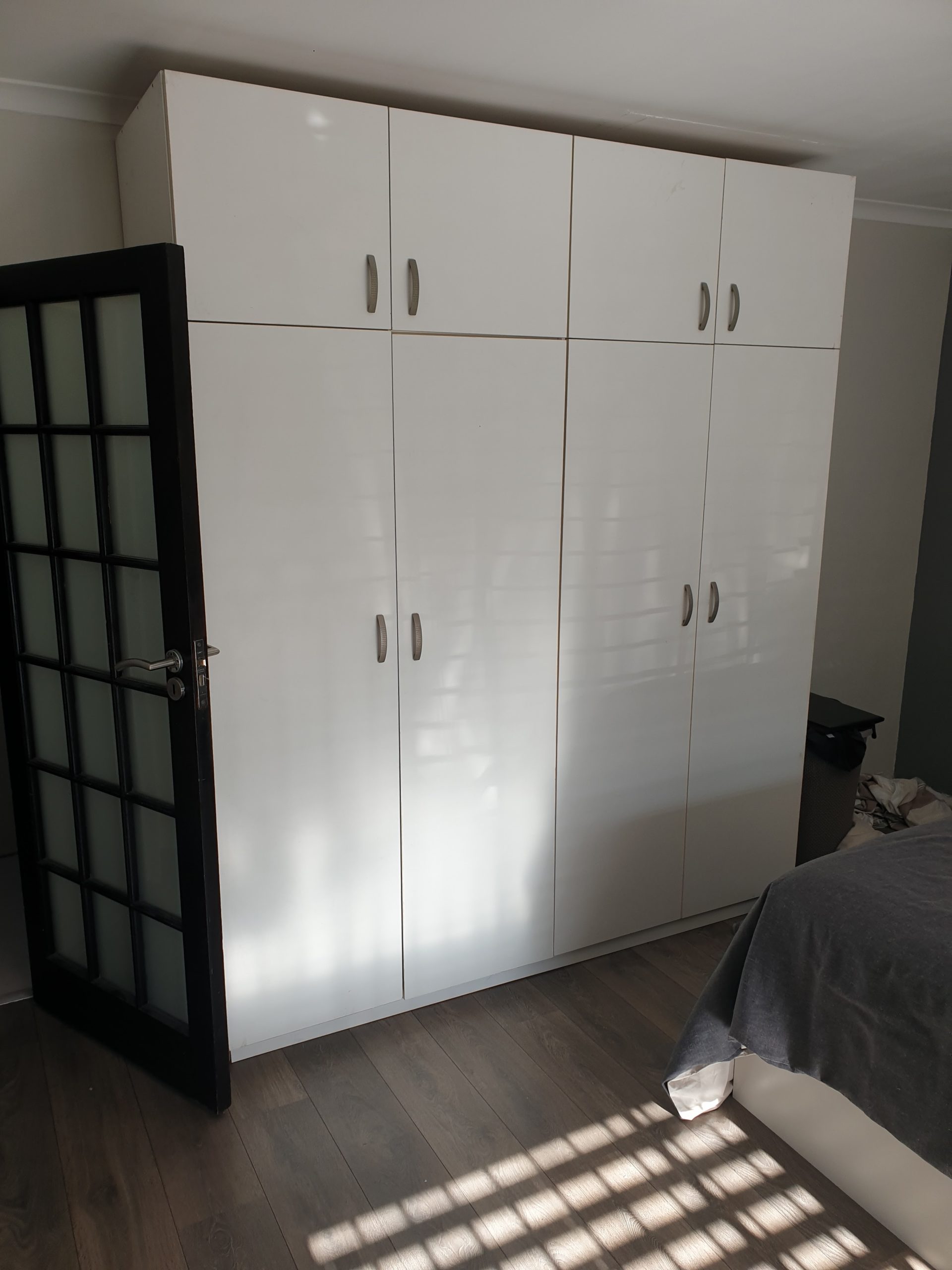 Gloss white built in bedroom cupboards and storage space