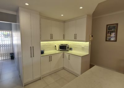beautiful kitchen installation by Bespoke designs featuring white cupboard doors and light coloured countertops 8