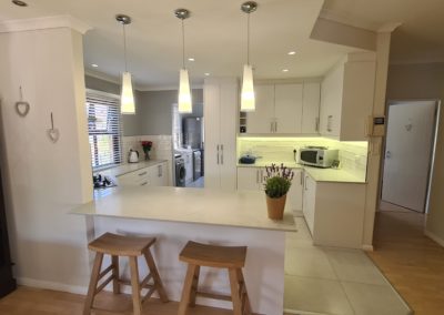 beautiful kitchen installation by Bespoke designs featuring white cupboard doors and light coloured countertops 7