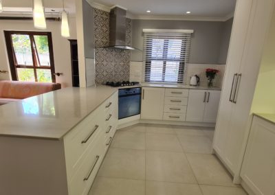 beautiful kitchen installation by Bespoke designs featuring white cupboard doors and light coloured countertops 6