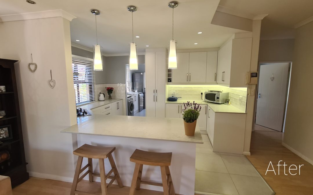 beautiful kitchen installation by Bespoke designs featuring white cupboard doors and light coloured countertops