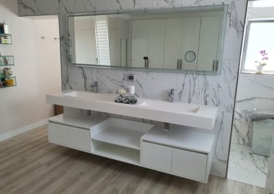 custom white vanity suspended under the basin sink with doors and table tops in gloss white 3