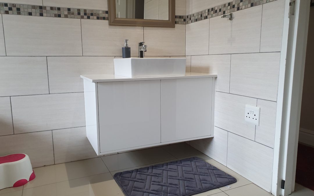 Custom vanity installed suspended off the floor with basin